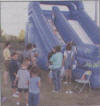 children wait turn to slide down inflatable.jpg (46510 bytes)